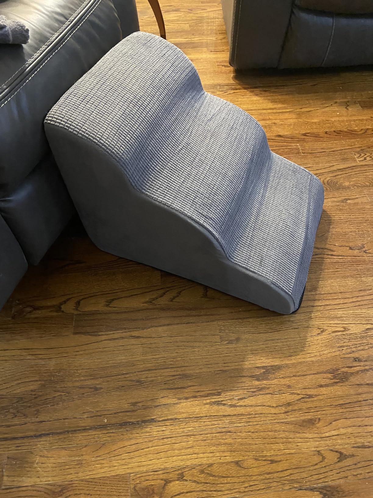 Curved Foam Pet Steps beside a sofa